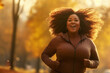 Young plus size woman running in city park on sunny autumn day. Overweight young girl jogging in the street. Weight loss concept.