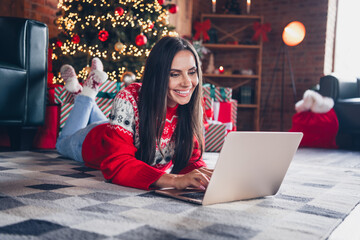 Poster - Photo of charming cheerful cute girl dressed red sweater lying on carpet watching video movie enjoying relax rest magic season indoors