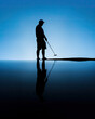 silhouette of a man holding a golf club in a minimalist blue background 