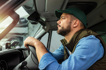 Wall Mural - Young handsome man working in towing service and driving his truck.