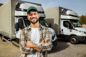 Wall Mural - Happy confident male driver standing in front on his truck