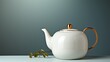 A gleaming ceramic teapot, adorned with a regal gold lid, rests upon a rustic branch, bringing a touch of elegance and nature to any indoor tea time