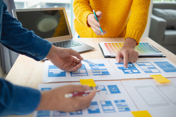 Wall Mural - the designer team is designing the uxui system to make the uxui system work well on new phones and s