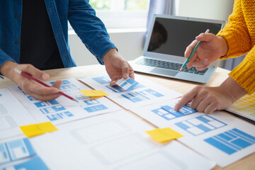 Wall Mural - the designer team is designing the uxui system to make the uxui system work well on new phones and s