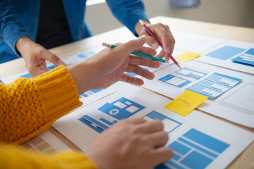 Wall Mural - the designer team is designing the uxui system to make the uxui system work well on new phones and s