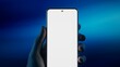 © ivanbaranov - Caucasian male holding a phone in vertical orientation against vivid background