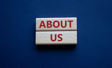 Sticker - About us symbol. Wooden blocks with words About us. Beautiful deep blue background. Business and About us concept. Copy space.