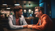 © javier - A mentor and mentee enjoying a light-hearted exchange during a startup guidance session.