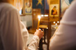 Orthodox church candle background. Hand holding candle during ceremony. Baptism ceremony in East of Europe.