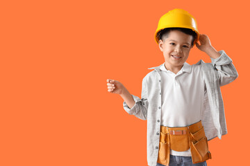 Poster - Cute little worker in hardhat pointing at something on orange background