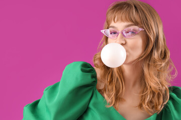 Canvas Print - Beautiful young woman with chewing gum on purple background, closeup