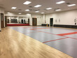 A well-equipped martial arts studio with training mats and a focused atmosphere for practitioners.