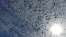 Blue Sky With Sun And Moving Cirrocumulus Clouds - Timelapse. Topics: Texture Of Clouds, Weather, Meteorology