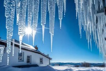 Glistening Icicles Hanging From The Roof Of A House, A Winter Scene That Sparkles With The Beauty Of Nature's Ice Sculptures