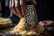 cheese being grated by a person, Shredded cheese a close up of an amazing ingredient 