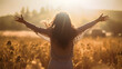 © FutureStock - Happy woman standing with open hands back view on sunset