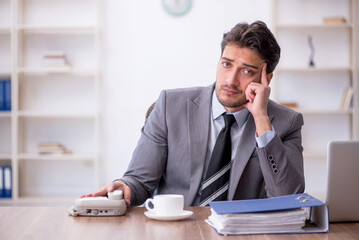 Young male employee working in the office