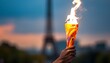 African american hand raising the olympic torch in front of the Eiffel tower, Paris