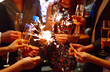 © maxbelchenko - Glowing sparkles in hands. Group of happy people enjoying party with fireworks. Winter holiday.