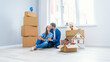 © gorynvd - Caucasian couple moving in new home. Young stylish couple in moving in mess.