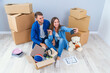 © gorynvd - Young couple taking selfies in their new home while sitting among cardboard boxes. Happy attractive young couple is moving, making a selfie, cuddling and smiling.