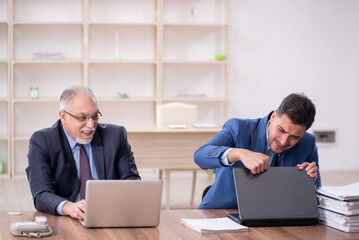 Canvas Print - Two male employees working in the office