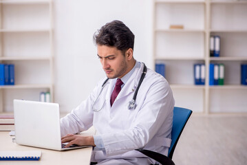 Young male doctor in telemedicine concept