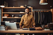 © VisualProduction - Handsome young indian male clothing boutique owner standing behind counter and smiling, personal shopping assistance helping client