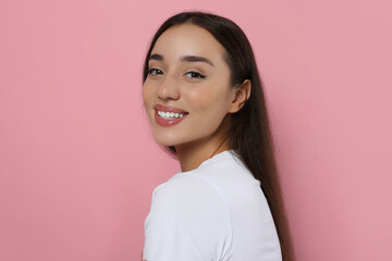 Poster - Portrait of beautiful young woman with elegant makeup on pink background