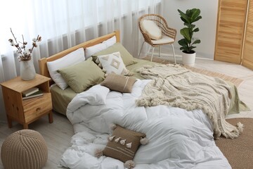 Wall Mural - Large comfortable bed with soft pillows, duvet and blanket in room. Home textile