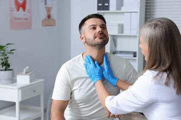 Sticker - Endocrinologist examining thyroid gland of patient at hospital