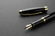 Stylish fountain pen with cap on black background, closeup. Space for text
