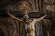 Painted wooden sculpture of Jesus Christ being crucified