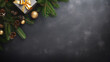 black wooden table with decoration with fir branches and christmas gifts in top view and copy space