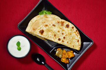 Wall Mural - Top view of plain paratha served with dahi and achar