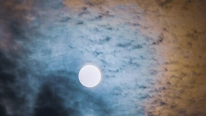 Wall Mural - magic of the night sky. time lapse of full moon and moving clouds. full moon against blue and orange