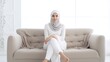 © almeera - Muslim woman is relaxing sitting on the sofa