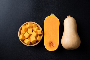 Canvas Print - Butternut squash pumpkin prepare for cooking in Autumn season on black background