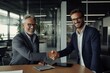 © radekcho - Smiling middle aged business man handshaking partner, making partnership collaboration agreement at office meeting. HR manager and new worker shake hands recruiting at job interview.