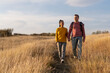 © Space_Cat - Young couple hiking through autumn fields and hills during warm day. Weekend, leisure, sport