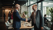 © javier - In a bustling co-working space a project manager extends a congratulatory handshake to a key contributor expressing gratitude for their indispensable role in a critical project.