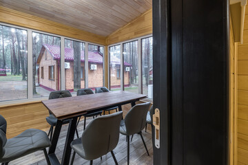 Wall Mural - table with chairs in entrance hall in wooden country eco house