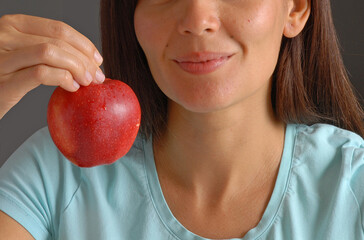 Young woman holding a red apple fruit portrsit.