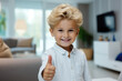 Little positive boy showing thumb up, like gesture