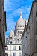 The south facade of the basilica of the Sacre-Coeur, or sacred heart,through the streets of Montmartre, Paris.
