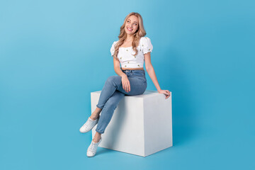 Wall Mural - Full length photo of adorable thoughtful lady wear white blouse looking empty space isolated blue color background