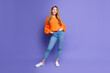 Full size photo of satisfied glad person put hands pockets posing empty space ad isolated on violet color background