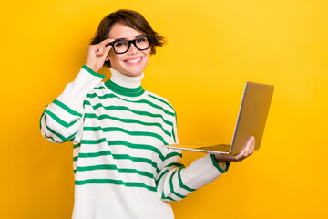 Poster - Photo of sweet cheerful girl dressed striped sweater eyewear working modern device isolated yellow color background