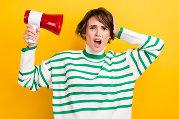 Poster - Photo of impressed unsatisfied person hold loudspeaker arm touch head open mouth unbelievable isolated on yellow color background