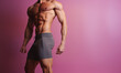 © IBEX.Media - Male fitness model shirtless torso from profile slightly tilted in front of pink background